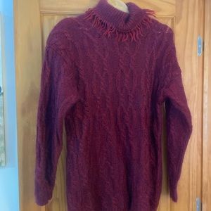sweater in a beautiful burgundy color, turtleneck with fringe for added style